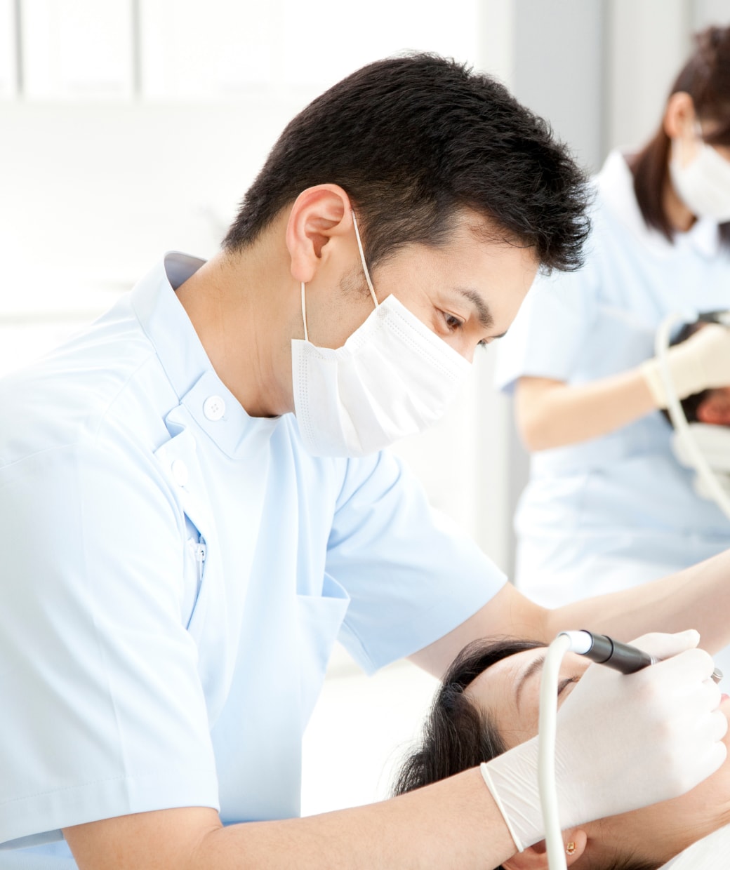 歯科医が歯の治療をしている写真